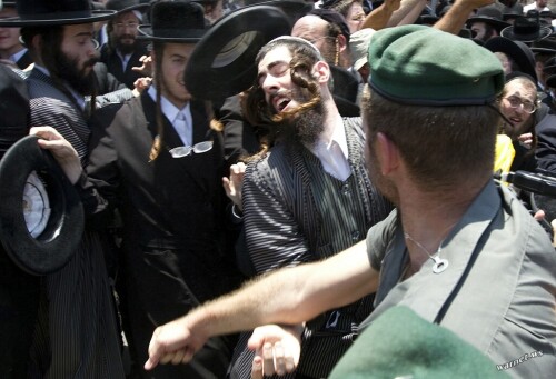 Anti-Zionist, Ultra-Orthodox Jewish men clash with Israeli police as they protest against the removal of ancient tombs in Jaffa, just south of Tel Aviv, on June 16, 2010 where construction is due to take place at the site where religious men say Jewish graves are located. AFP PHOTO/JACK GUEZ (Photo credit should read JACK GUEZ/AFP/Getty Images)(Photo Credit should Read /AFP/Getty Images)           NYTCREDIT: Jack Guez/Agence France-Presse -- Getty Images
